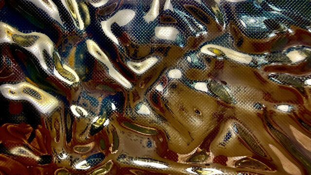 abstract liquid metallic texture with golden reflections and glossy chrome ripples creating an futuristic wavy background