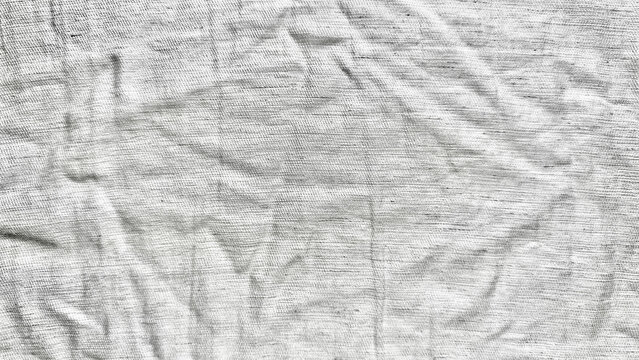 wrinkled white linen fabric texture creates an organic abstract background pattern with shadows for sustainable branding
