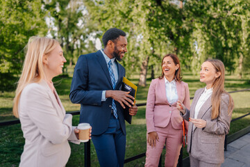 Fototapeta premium Business colleagues networking and communicating in park