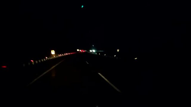 Night Driving on Dark Highway with Distant Car Lights