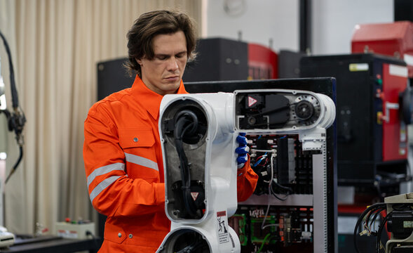 Robotic engineer examining robot power gear machine for repairing service. Modern technology technician working on hardware maintenance to repair steel and metal part of industrial automated equipment