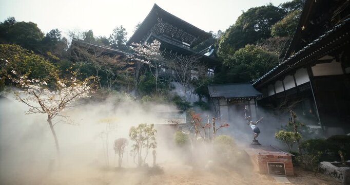 Mist Drifting Through Ancient Traditional Japanese Temple Courtyard