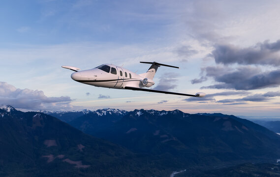 Private Jet Flying Over Snowy Mountains At Sunset &mdash; Business Aircraft 3D Rendering Background In BC, Canada