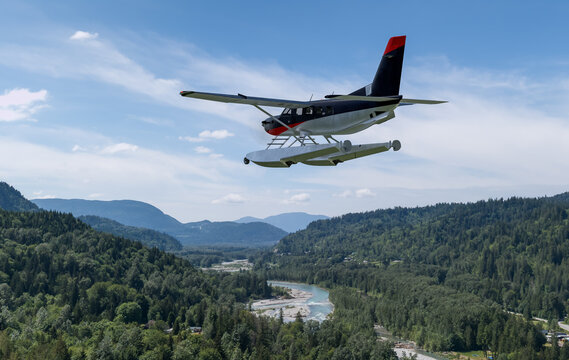 Floatplane Over Mountain Valley With River Below &mdash; Seaplane Flight in BC, Canada, 3D Rendering
