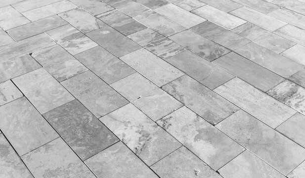 Close-up of gray stone tile flooring, black and white photography
