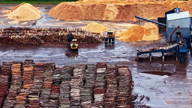Wide aerial video of machinery working at Stora Enso Sawmills in Helsinki, Finland in Europe. Produced with Rec709 color.