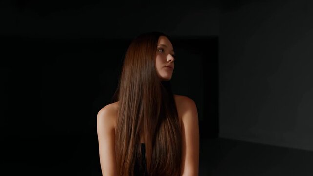 Serene young woman with long hair in a minimalist setting, embodying calmness and introspection. A representation of beauty and self-reflection