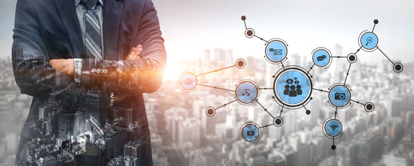 A professional businessman stands confidently against a city skyline, showcasing connectivity icons that symbolize digital transformation and modern networking strategies. Tessel © InfiniteFlow