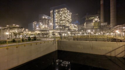 Naklejka premium Modern Coal Fired Power Plant and Water Treatment Facility at Night