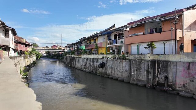 urban canal flowing through residential neighborhood in Yogyakarta
