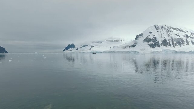 Tall Ship in Antarctic Bay with Mountain Backdrop