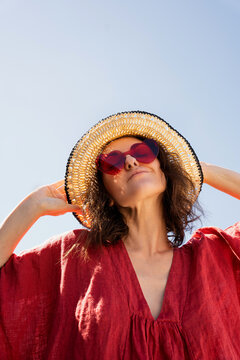 Woman Posing in Straw Hat and Sunglasses