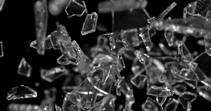 Glass shards exploding and scattering in ultra slow motion at 1000 fps. High-detail fragments suspended in air, creating dramatic cinematic impact visuals.