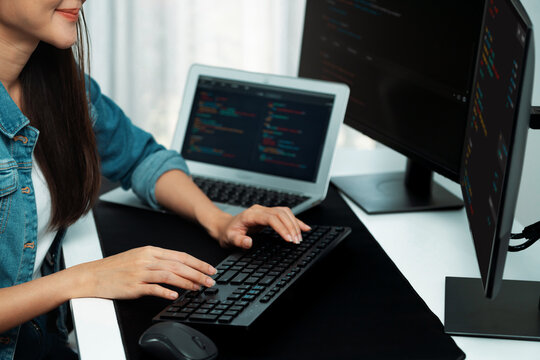 Cropped hands image of IT developer creating with typing information on pc with coding program information data website application, wearing jeans shirt surround safety analysis two screen. Stratagem.