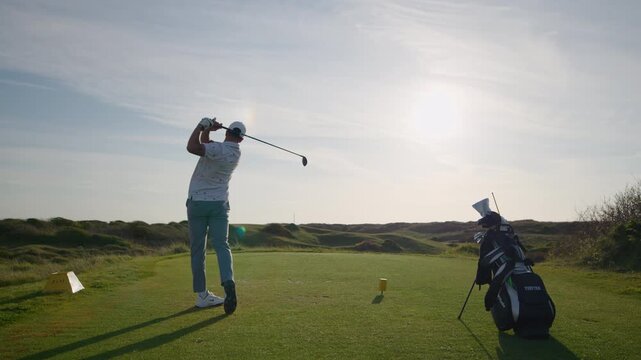 Crane shot of Golfer swing and hitting ball of tee, driver shot slomo