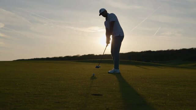 Sunset golf course putting shot misses hole, disappointment