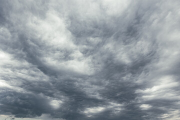 Fototapeta premium Dramatic gray clouds covering the sky. Dark storm weather background.