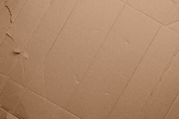 Fototapeta premium Brown kraft cardboard surface with fold marks, soft creases and authentic paper texture. Minimal abstract background from recycled packaging material