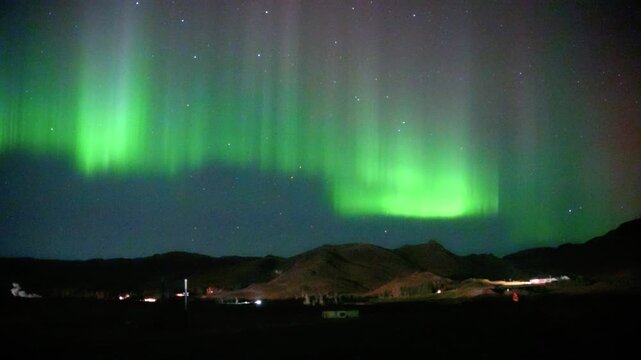 Starry Night Sky And Green Aurora Borealis Over Hveragerdi In Iceland. - wide shot