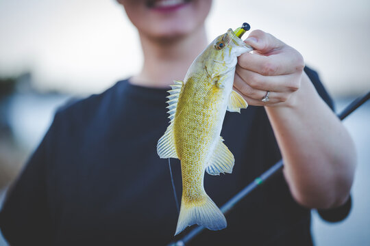 Woman holding freshly caught Smallmouth Bass