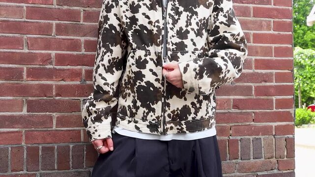 Video of a person pulling zipper of his jacket down.
