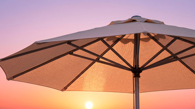 Close-up view of a patio umbrella against a vibrant sunset sky