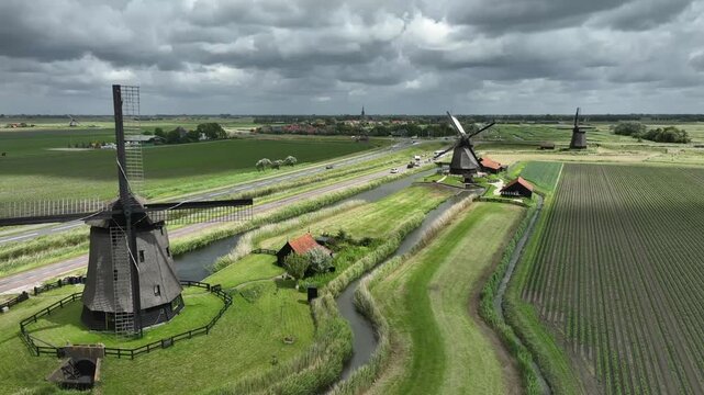 aerial footage of some traditional Dutch windmills near Schermerhorn, the Netherlands