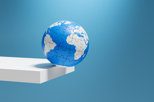 Puzzle globe balancing on edge showing global risk