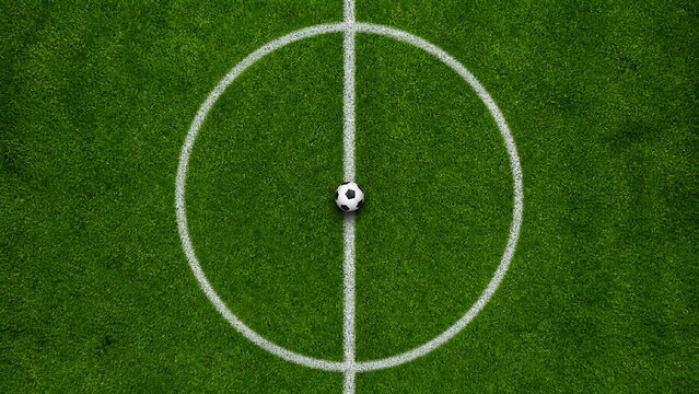 Soccer ball placed exactly in the center of the midfield line on a lush green professional stadium grass