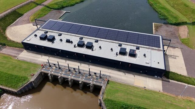 Close-up aerial view of St Germans Pumping Station pump house and river outfall channel, Norfolk, UK