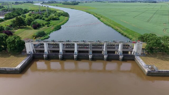 Aerial view of the Tail Sluice flood management barrier and river infrastructure near King's Lynn, UK.
