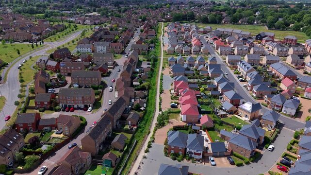 Aerial view contrasting modern new build housing development alongside established old residential estate in Ely Cambridgeshire UK