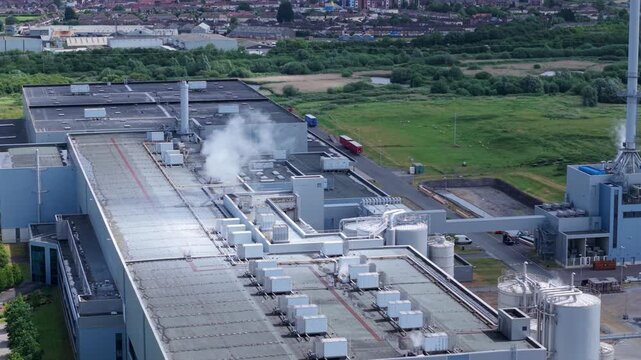 Aerial view of a massive industrial manufacturing factory with rooftop ventilation and steam vents near King's Lynn, UK