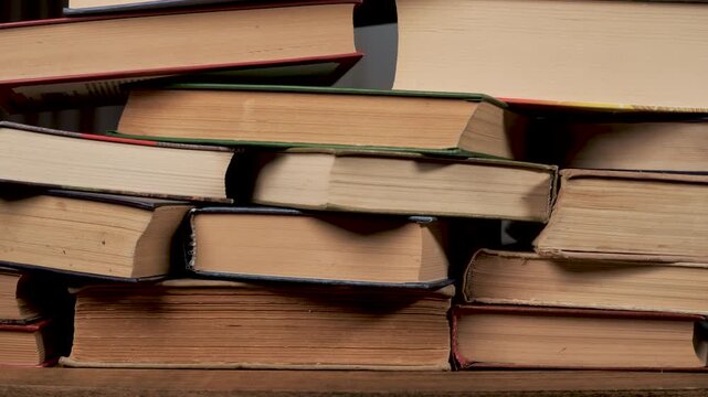 Stack of old hardcover books on wooden table education concept, close-up view of literature, knowledge and academic learning resources