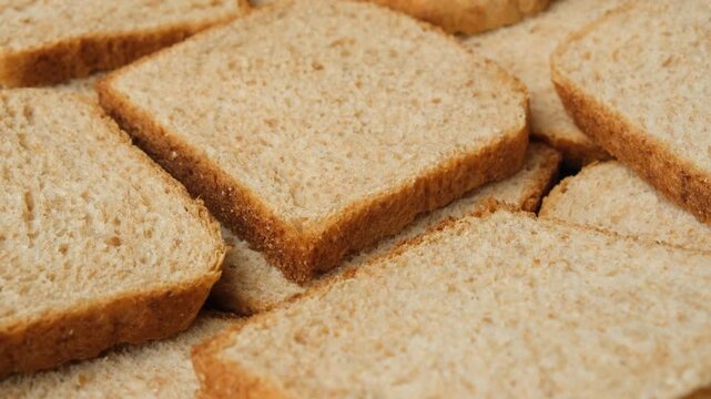 Food background with spinning whole wheat grain bread slices
