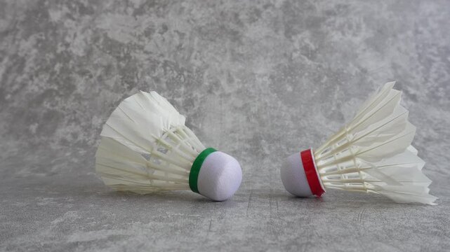 Shuttlecock falling on abstract gray background