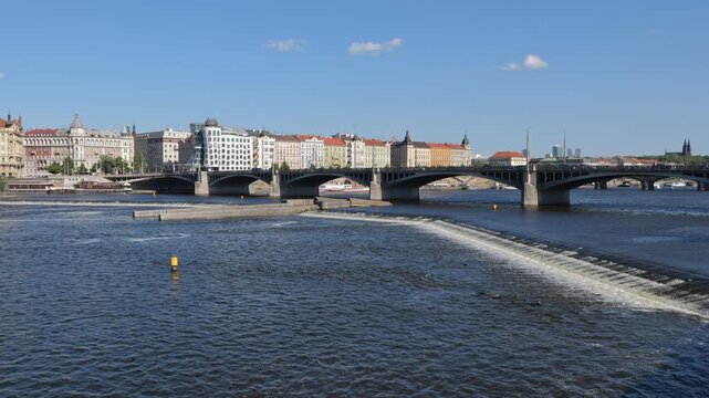 City skyline of Prague with Jirasek Bridge and weir on Vltava river in Czechia (Czech Republic).