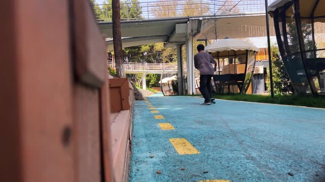 Skateboarder feet riding longboard on park path