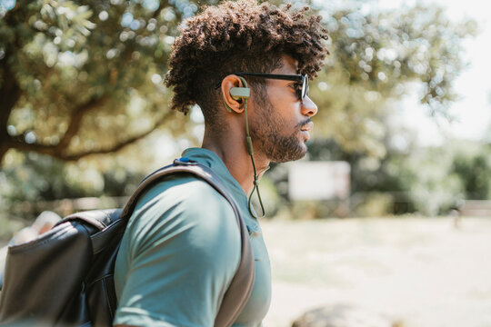 Young man with earphones in a park