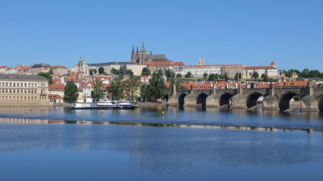 City of Prague at Vltava river in Czechia (Czech Republic). View to the Charles Bridge and Prague Castle on a hill.