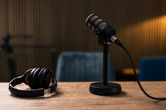 Microphone by headset on desk in recording studio