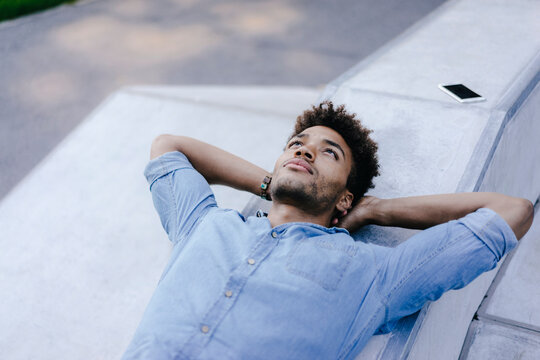 Portrait of relaxed man lying in skatepark