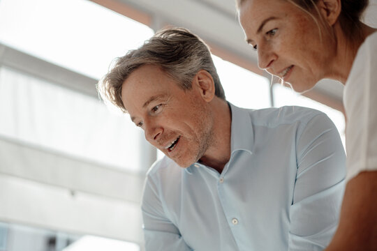 Businessman discussing with colleague in office