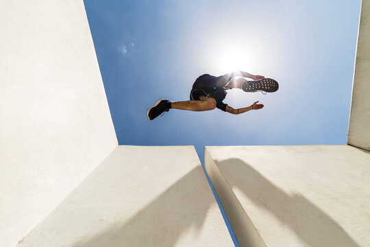 Man jumping in the city during a parkour session