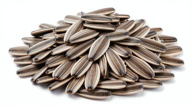Pile of striped sunflower seeds on white background. Dry seeds used for snacking baking cooking. Natural healthy food ingredient for birds animals.