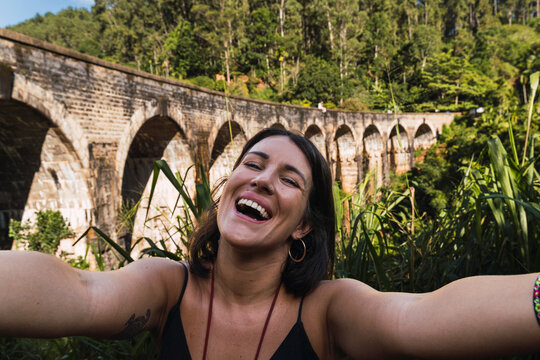 Happy tourist taking selfie at Nine Arches Bridge in Ella