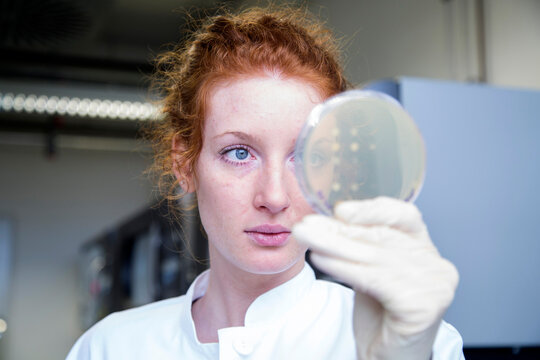 Young female natural scientist working in biochemistry laboratory