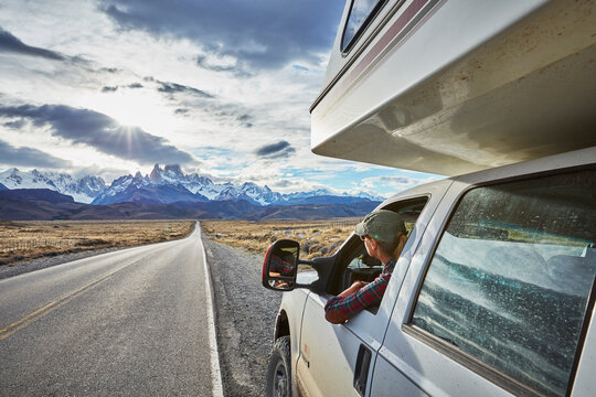 Argentina, Patagonia, El Chalten, woman looking out of window in camper on road towards Fitz Roy