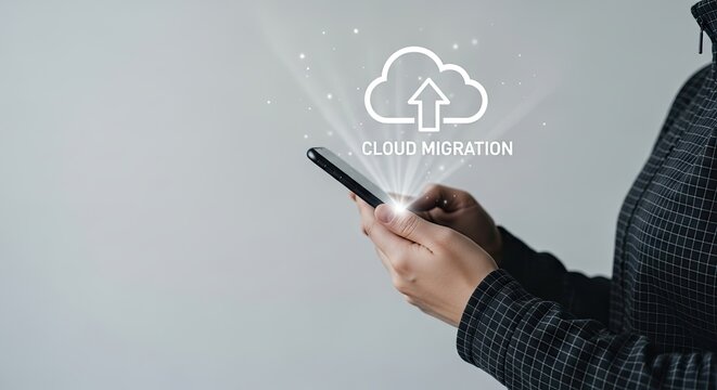 Person's hands holding smartphone showing cloud migration graphic with upload arrow during digital data transfer