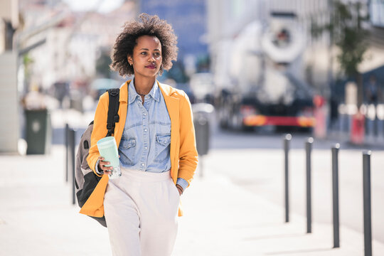 Young woman in the city on the go